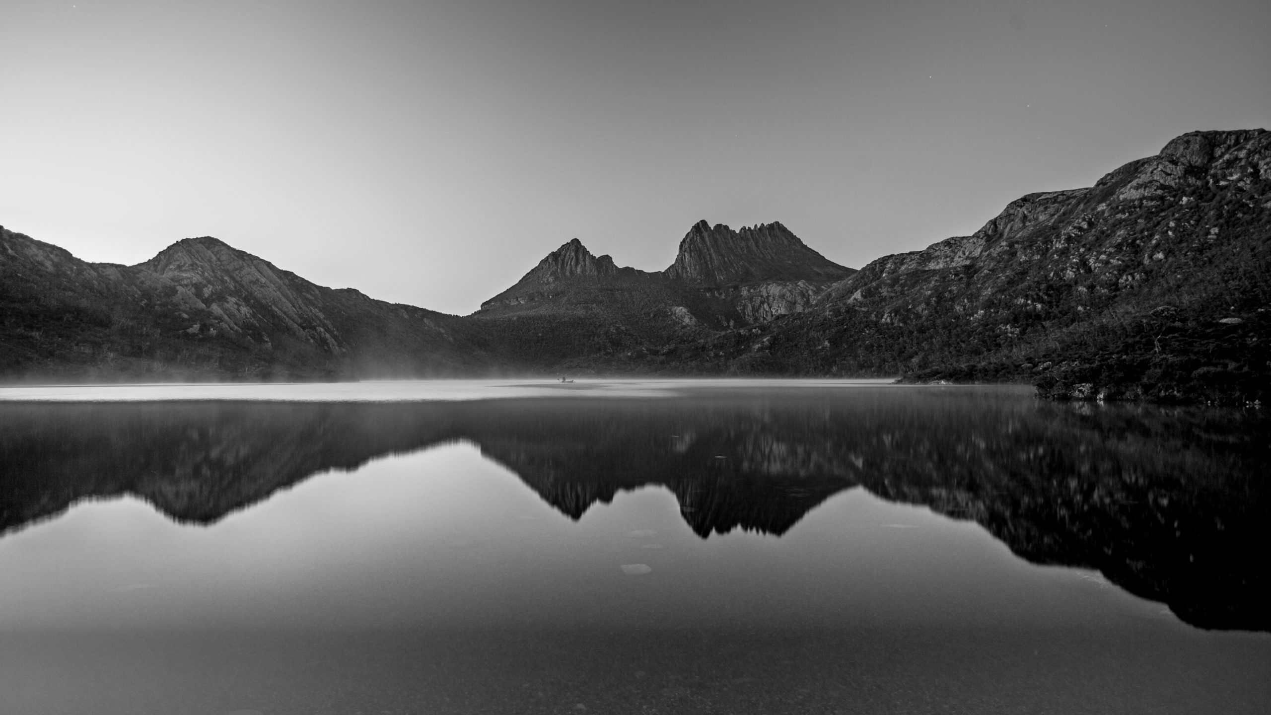 A lake sits at the base of mountains